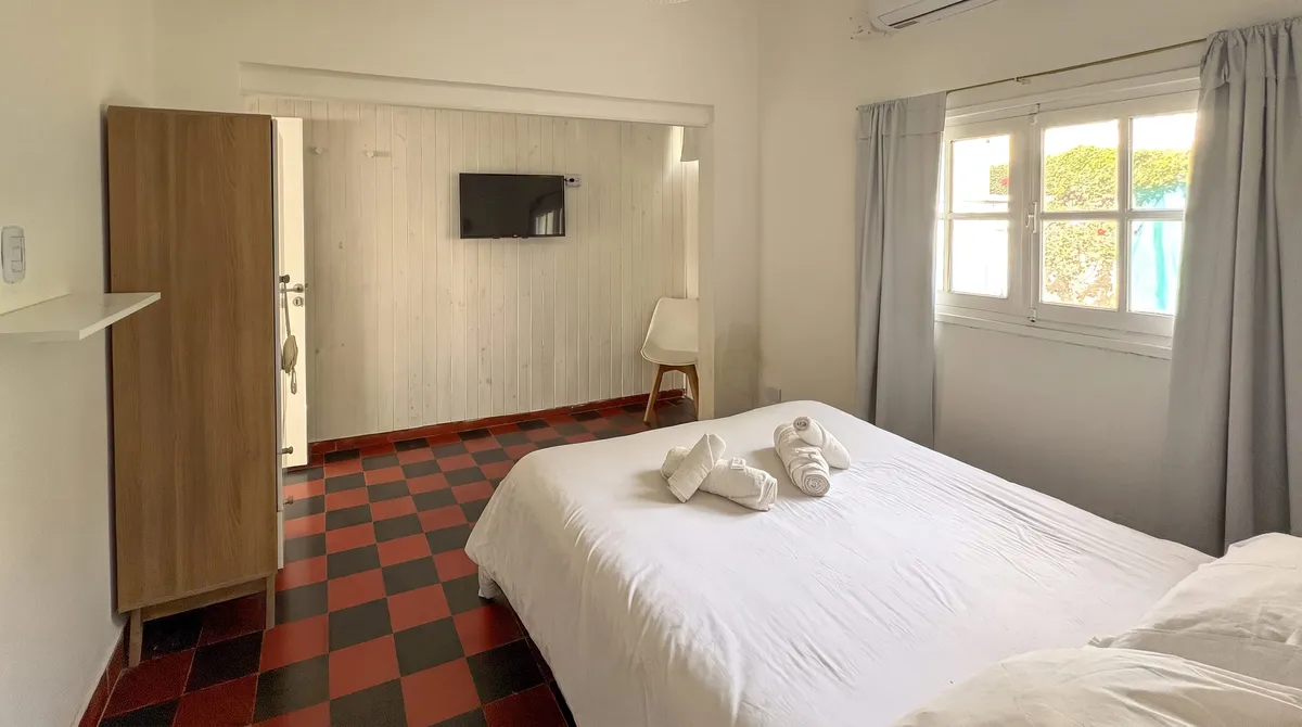 The bedroom from the door, with Smart TV and wardrobe