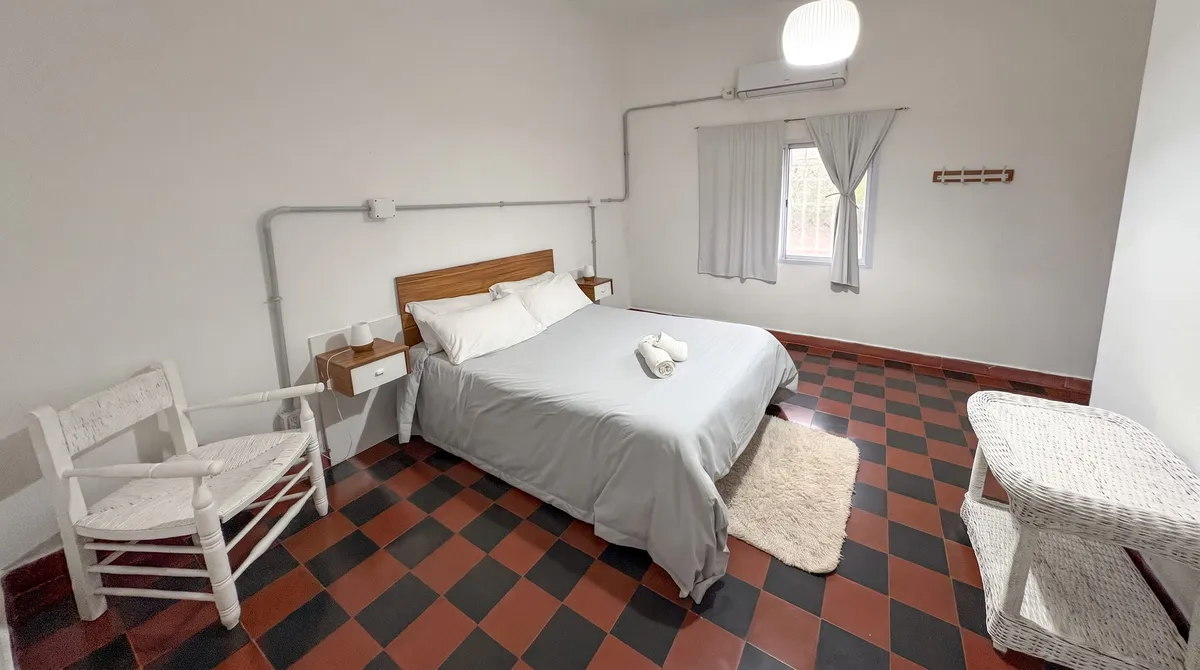 Main bedroom with a queen bed and heat-and-cool AC